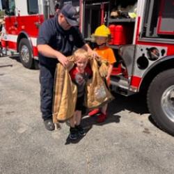 Children learn about the work of a firefighter